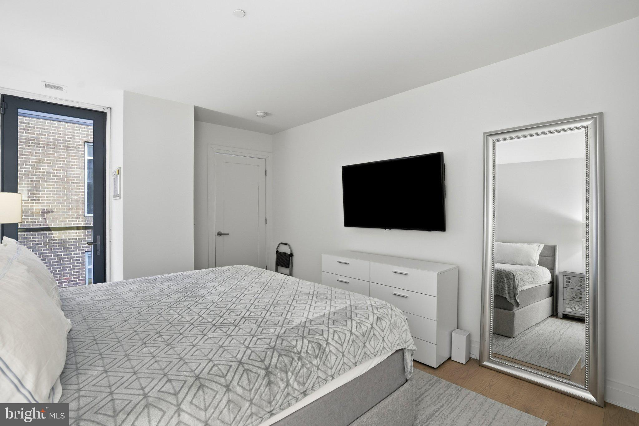 2501 M Street Northwest, Unit 209 Washington, DC 20037 - Photo 22 of 48 a bedroom with a bed and a flat screen tv