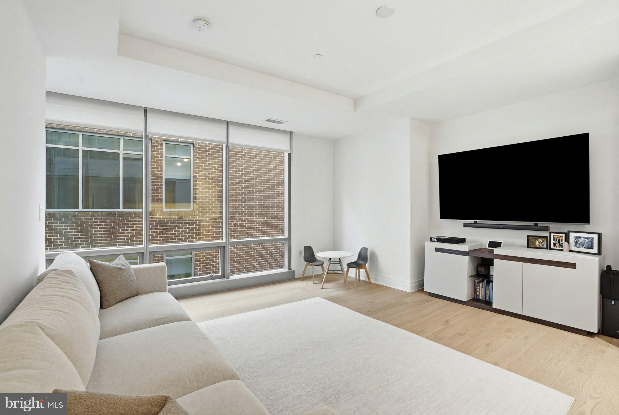 2501 M Street Northwest, Unit 209 Washington, DC 20037 - Photo 10 of 48 a living room with furniture and a flat screen tv