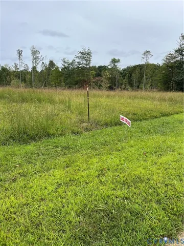 a view of a lake with houses in the back