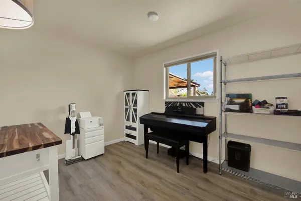 a room with a wooden floor and white walls