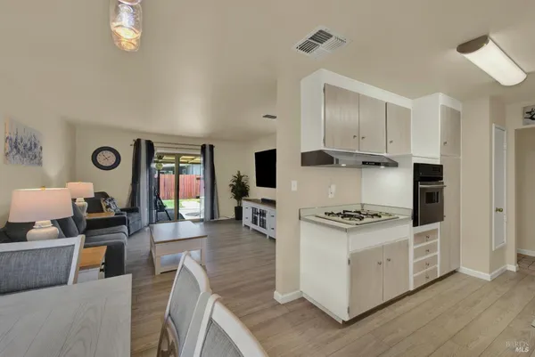 a kitchen with stainless steel appliances granite countertop a stove oven and a refrigerator with white cabinets