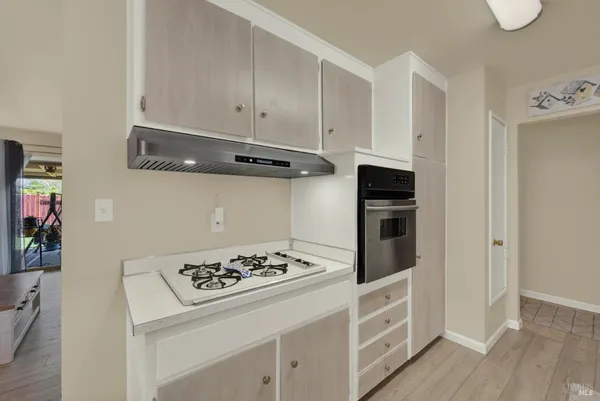 a kitchen with a sink a stove and chairs