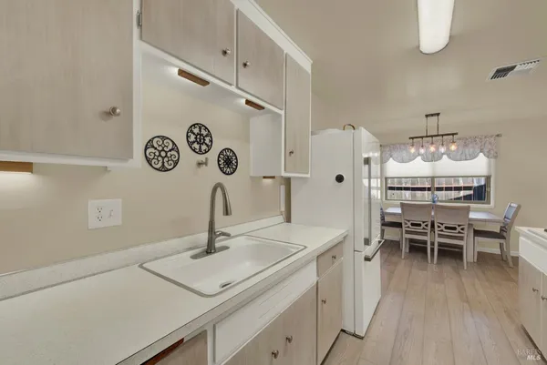 a kitchen with a stove and white cabinets