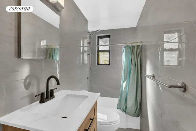 a bathroom with a sink toilet and a mirror