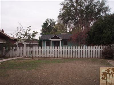 4258 Highland Place Riverside, CA 92506 - Photo 2 of 6 a view of a house with a small yard and fence