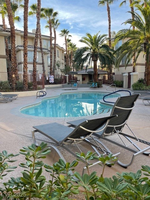 7155 South Durango Drive, Unit 306 Las Vegas, NV 89113 - Photo 18 of 19 Community pool featuring a patio