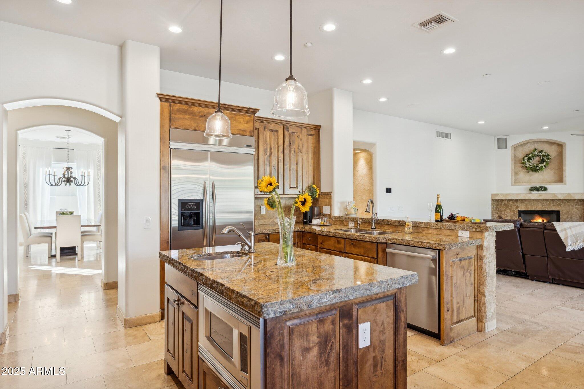 13174 East Geronimo Road Scottsdale, AZ 85259 - Photo 11 of 60 a kitchen with granite countertop kitchen island stainless steel appliances a sink stove and cabinets