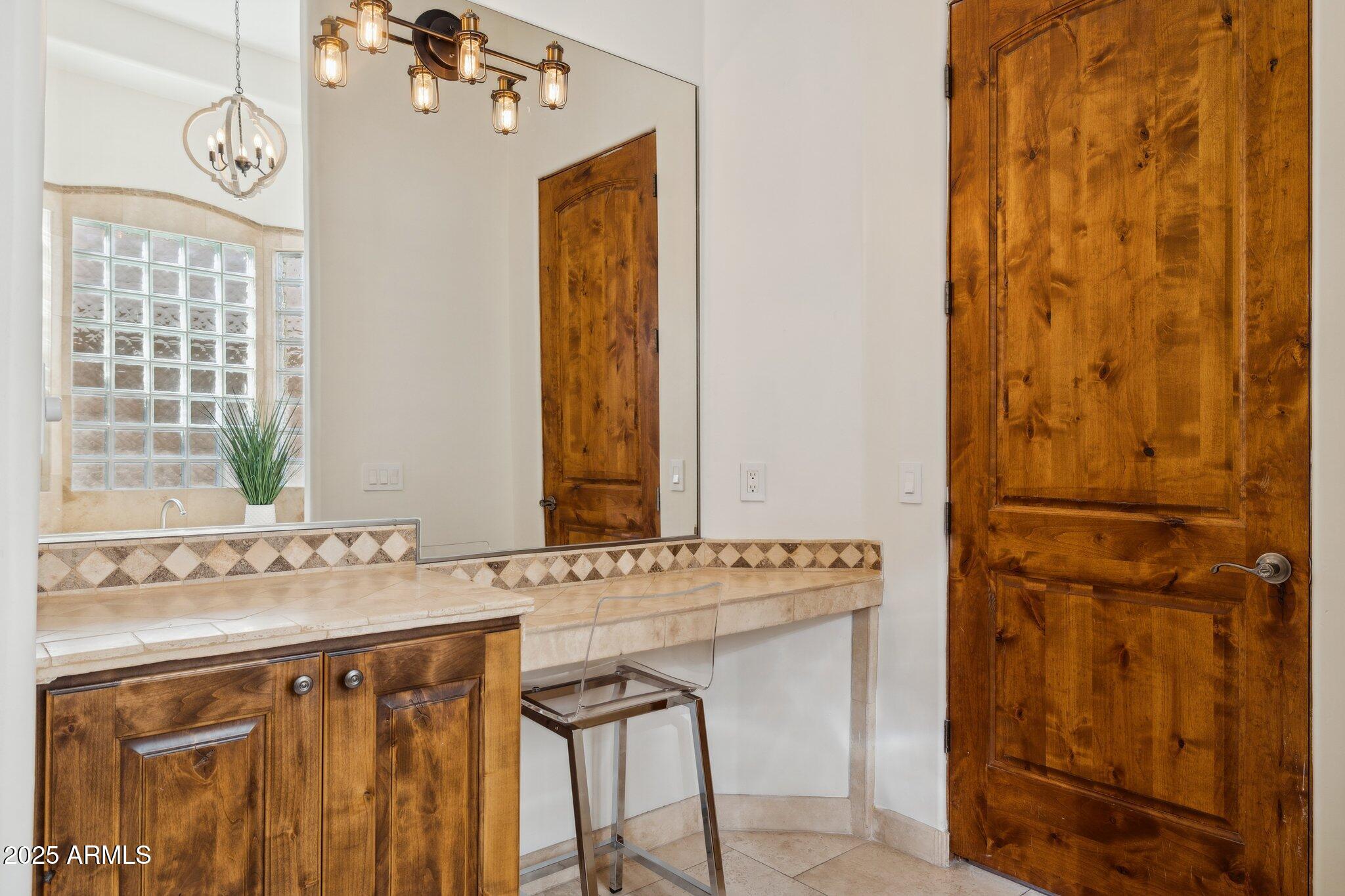 13174 East Geronimo Road Scottsdale, AZ 85259 - Photo 31 of 60 a bathroom with a sink a mirror and a window