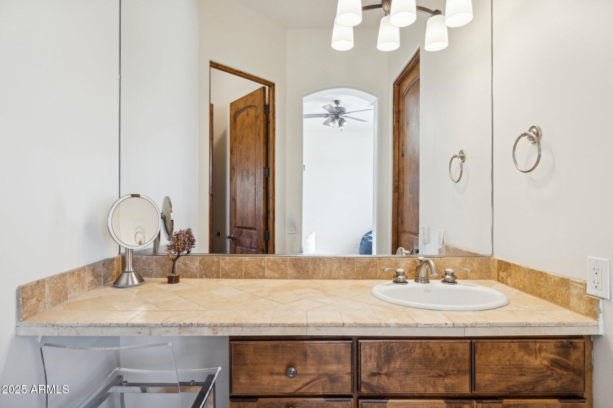 13174 East Geronimo Road Scottsdale, AZ 85259 - Photo 45 of 60 a bathroom with a granite countertop sink and a mirror