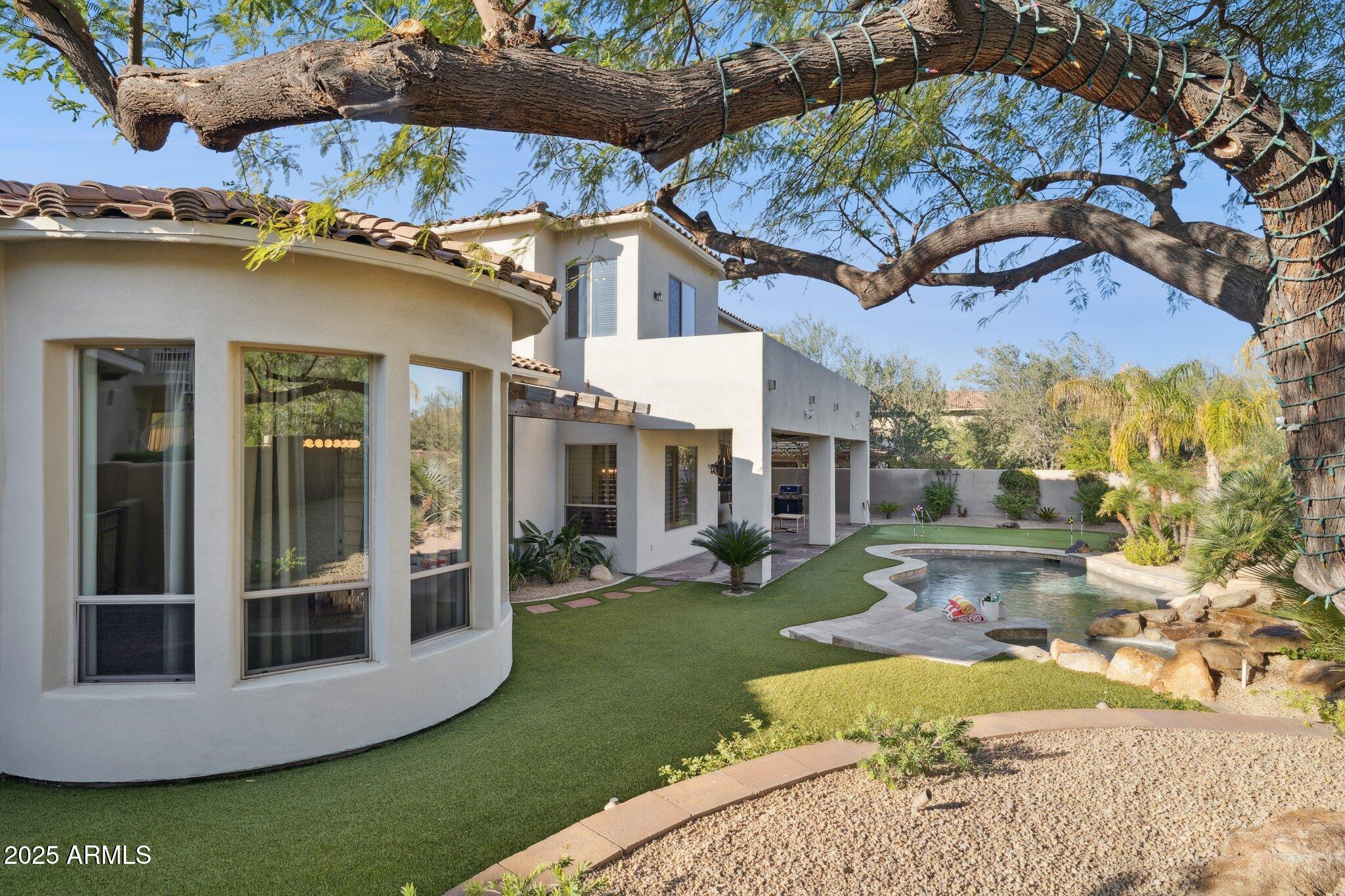 13174 East Geronimo Road Scottsdale, AZ 85259 - Photo 51 of 60 a view of a white house with a big yard and large tree