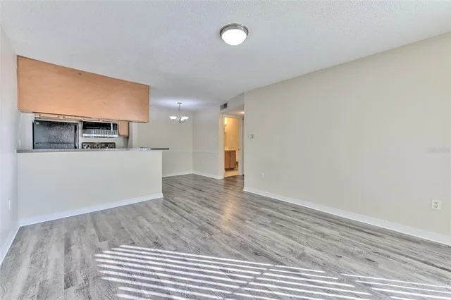 a view of a kitchen with a sink and a refrigerator