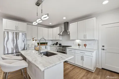 a kitchen with a center island appliances and cabinets