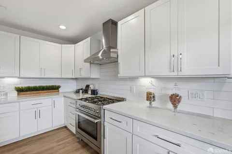 a kitchen with stainless steel appliances granite countertop white cabinets a sink and dishwasher