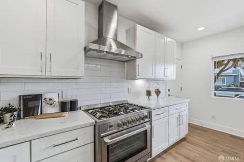 a kitchen with stainless steel appliances granite countertop a stove and a sink
