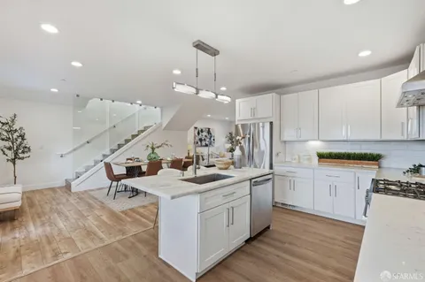 a kitchen with a sink cabinets and wooden floor