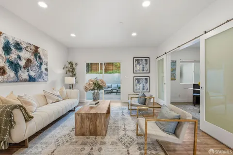 a living room with furniture and wooden floor