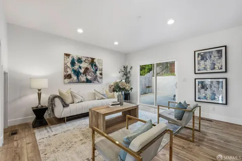a living room with furniture a rug and a wall painting
