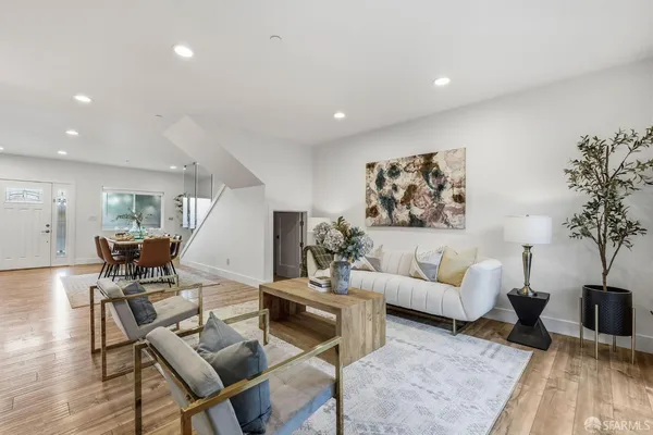 a living room with furniture and wooden floor