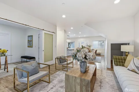 a living room with furniture potted plant and a table