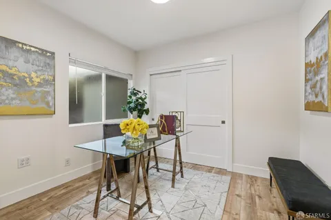 a view of a dining room with furniture and wooden floor