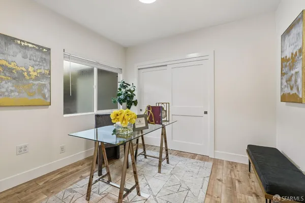 a view of a dining room with furniture and wooden floor