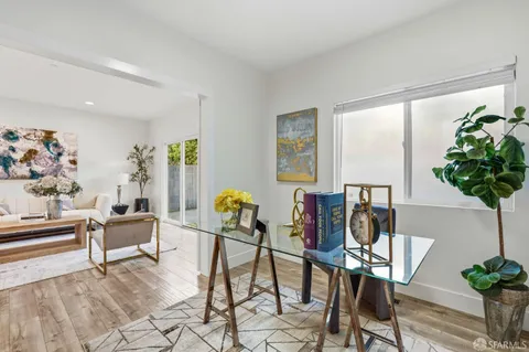 a living room with furniture and a potted plant