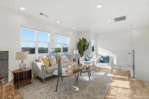 a living room with furniture a rug and a large window