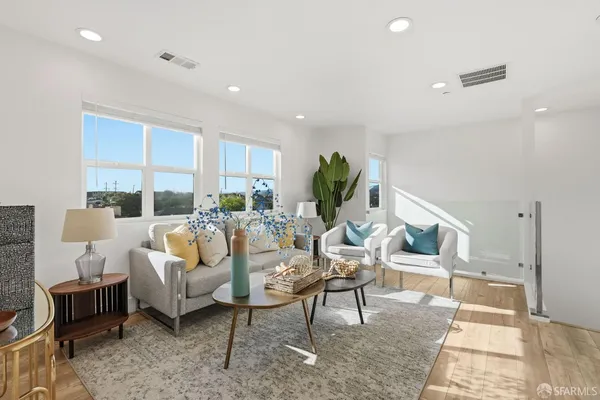 a living room with furniture a rug and a large window