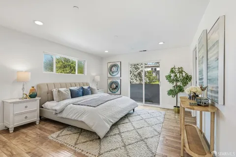 a bedroom with a large bed and a chandelier