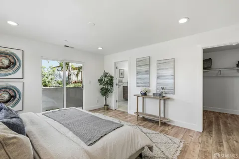 a bedroom with a bed and a chair