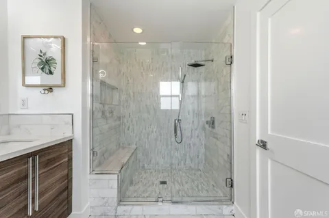 a bathroom with a shower and a sink