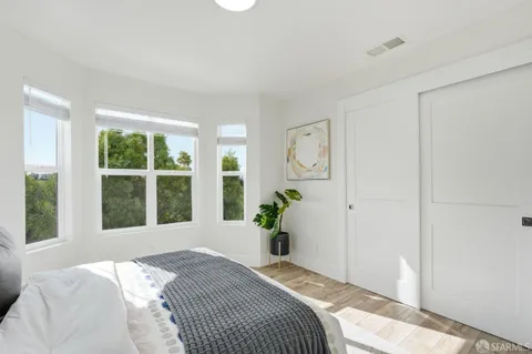 a bedroom with a bed and a large window