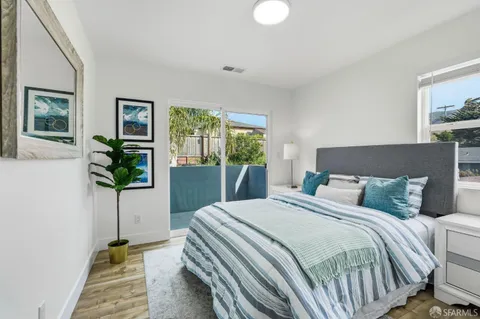 a bedroom with a bed and a potted plant