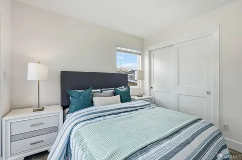 a bedroom with a bed and a night stand