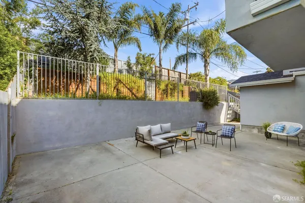 a view of a patio with a table and chairs and potted plants