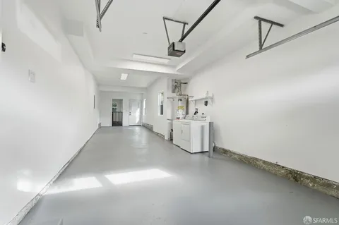 an empty room with windows and cabinet