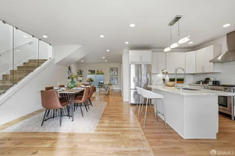 a view of a dining room with furniture and wooden floor