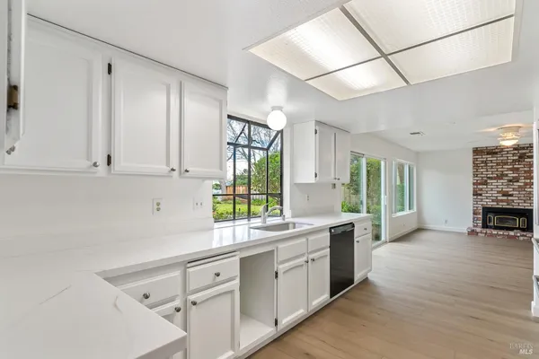 a kitchen with sink cabinets and wooden floor
