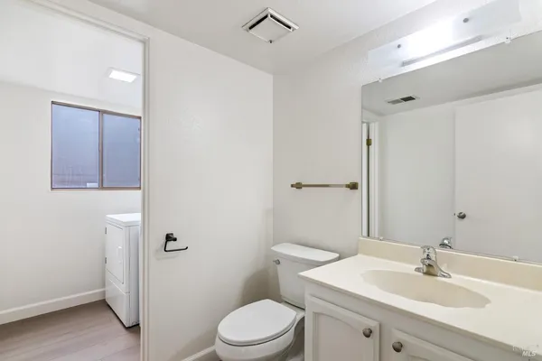 a bathroom with a sink toilet vanity and shower