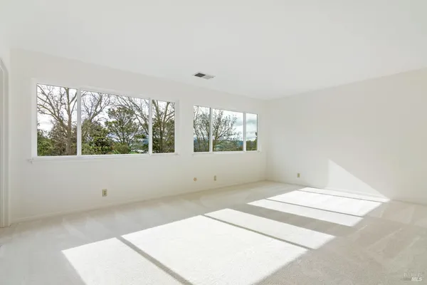 an empty room with large windows