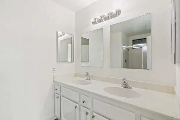a bathroom with a sink vanity and mirror