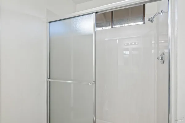 a bathroom with a glass shower door