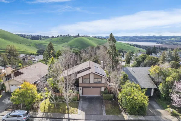 an aerial view of a house with a yard