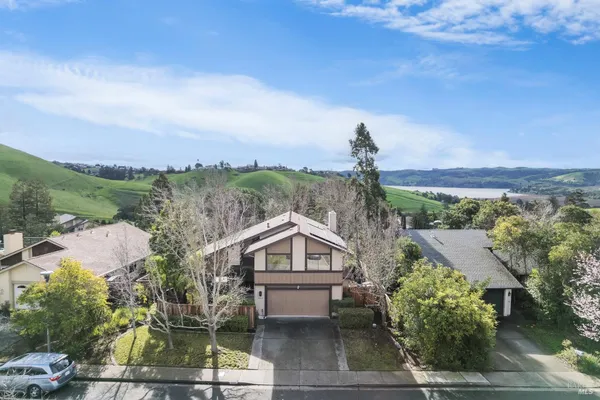 an aerial view of a house with a yard and garden