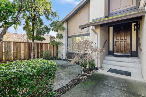 a view of a house with a small yard and plants