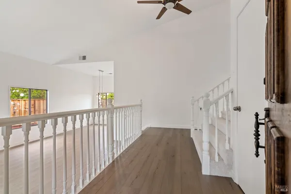 a view of a hallway with a hardwood floor