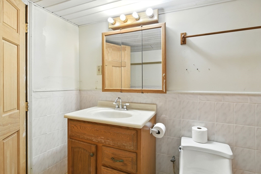 224 Cambria Street Springfield, MA 01118 - Photo 18 of 23 a bathroom with a sink vanity and a mirror