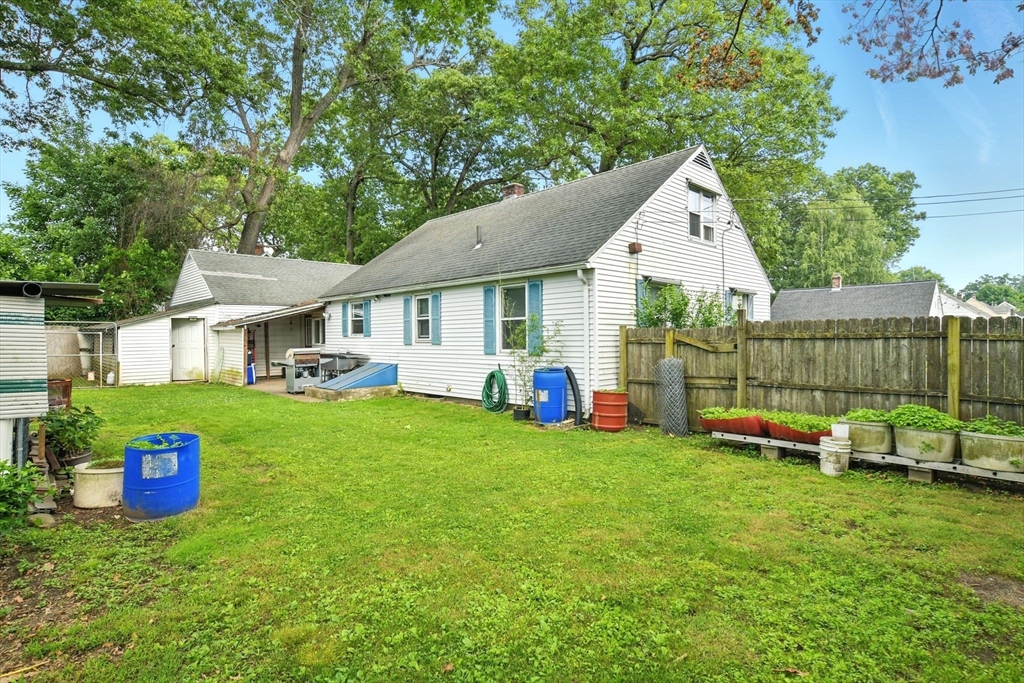 224 Cambria Street Springfield, MA 01118 - Photo 19 of 23 a view of a house with a backyard and a patio