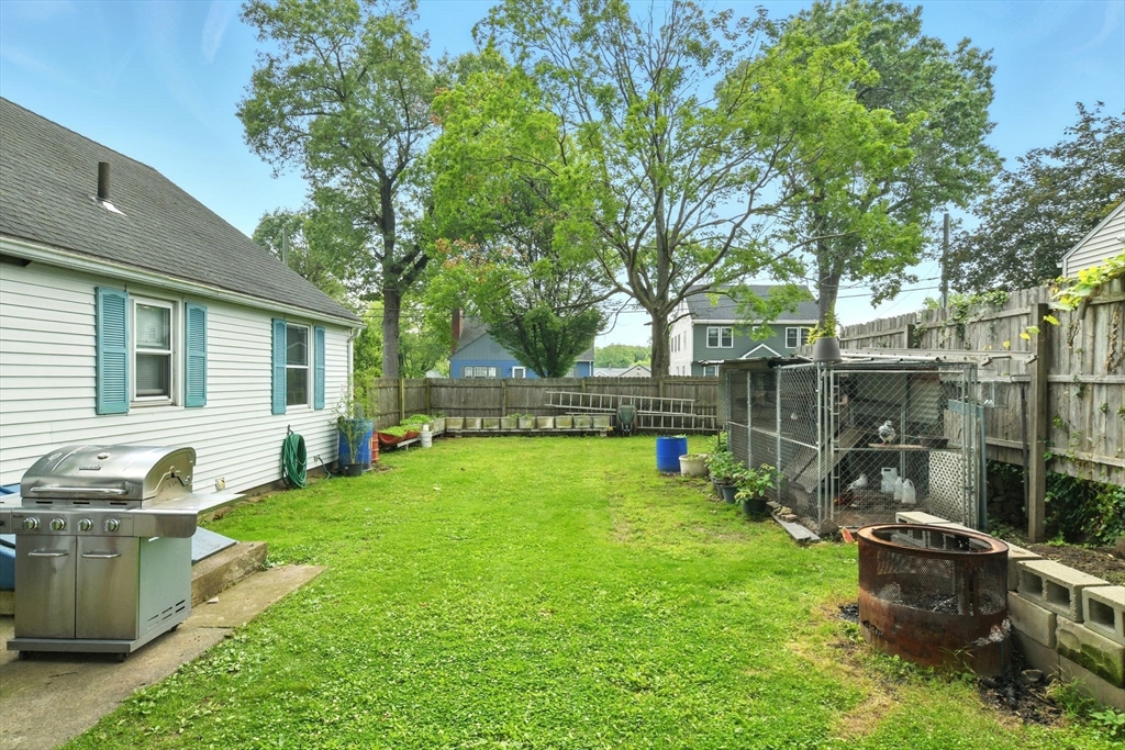 224 Cambria Street Springfield, MA 01118 - Photo 22 of 23 a view of a backyard with couches plants and large trees