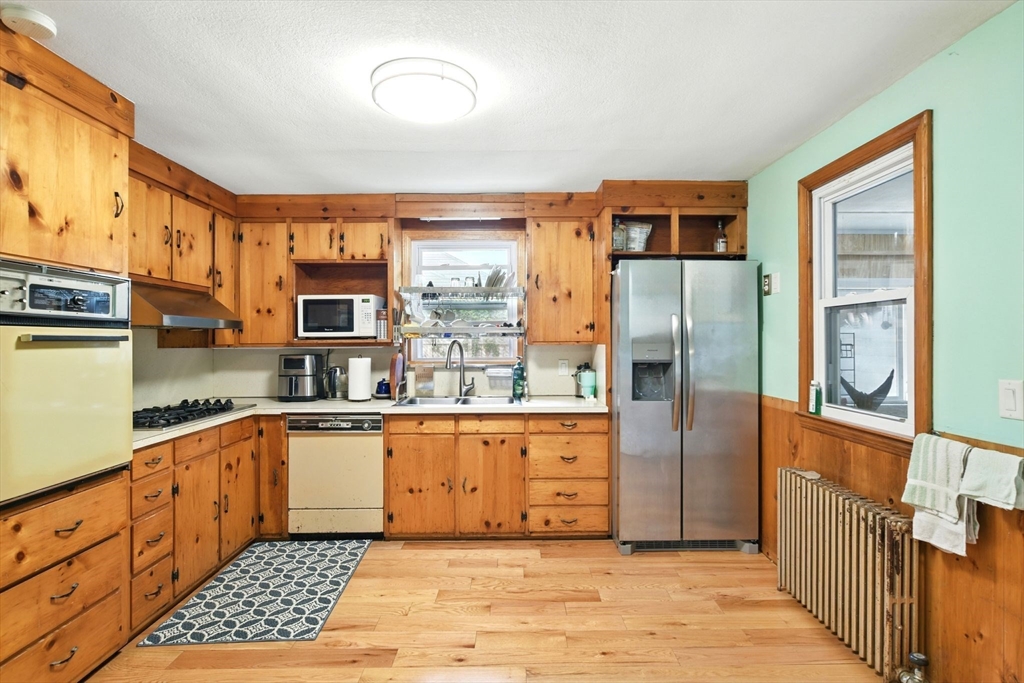 224 Cambria Street Springfield, MA 01118 - Photo 5 of 23 a kitchen with stainless steel appliances granite countertop a refrigerator and a stove top oven